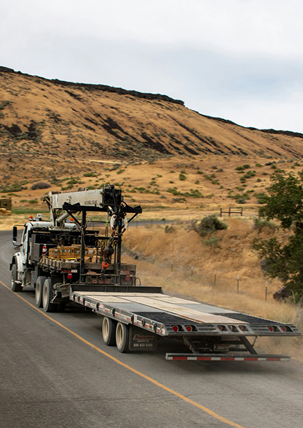Truck driving down a road.
