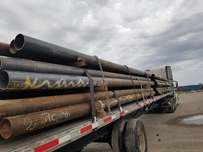 Oil pipes on a flatbed.